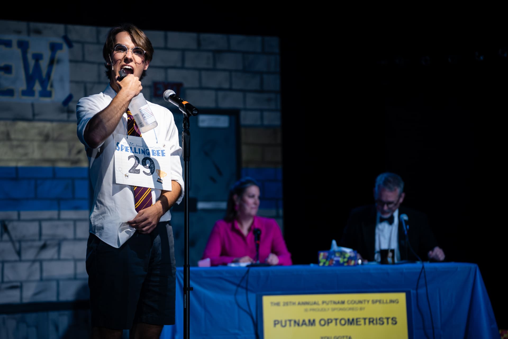 Richard Jordan singing at the microphone with his spray bottle before the judges