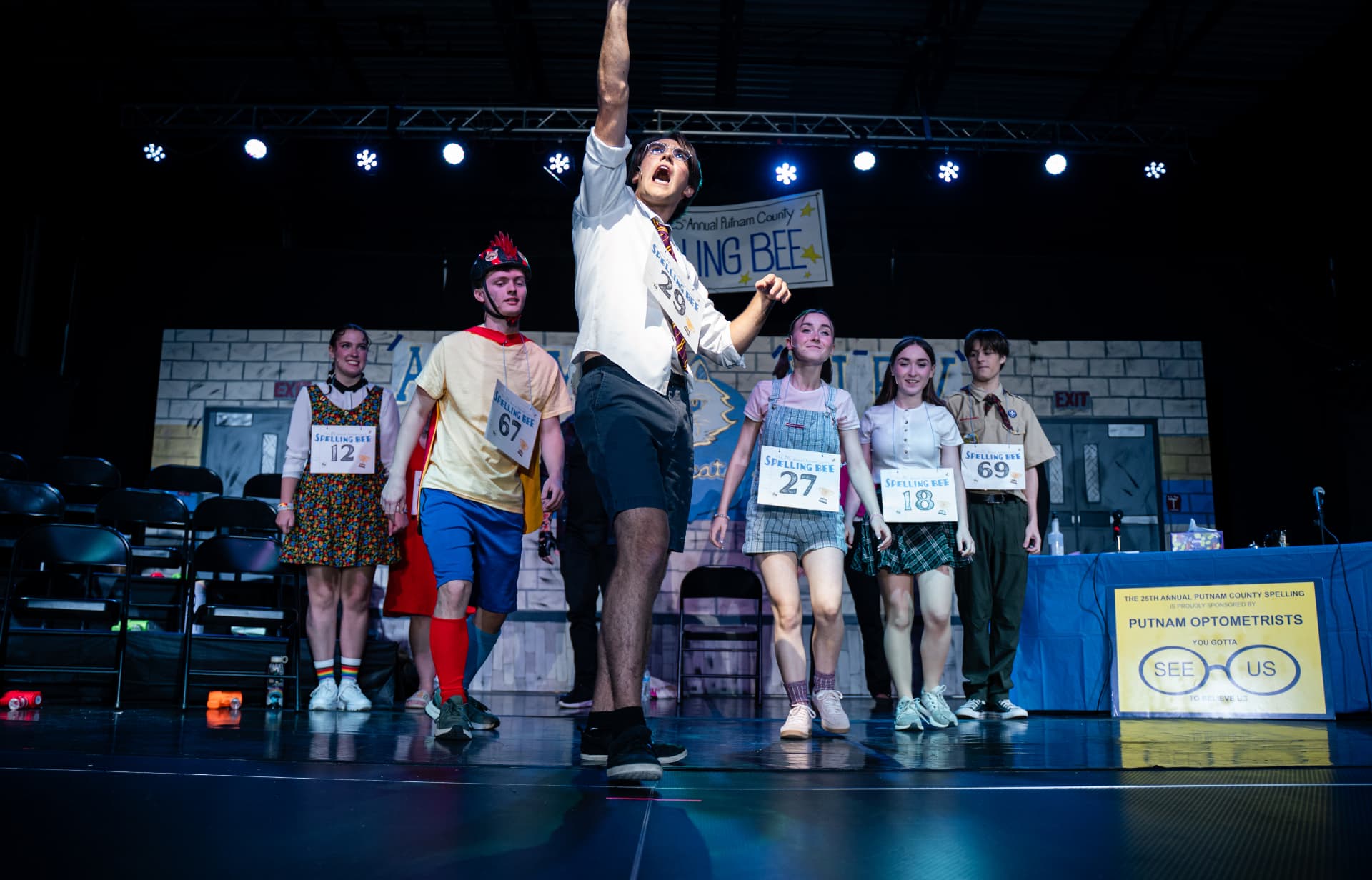 Richard Jordan center stage with the full Spelling Bee cast during the ensemble number