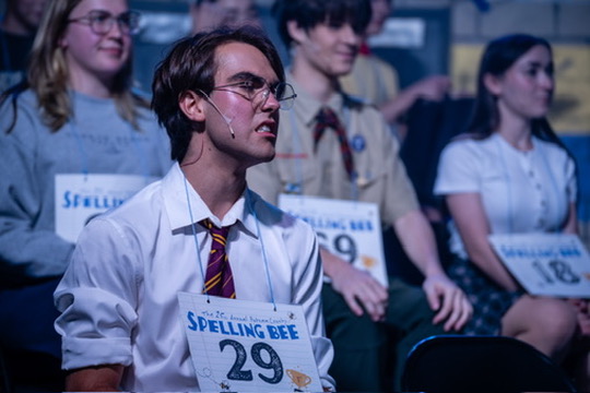 Richard Jordan seated among the spellers in the audience rows during Putnam County Spelling Bee