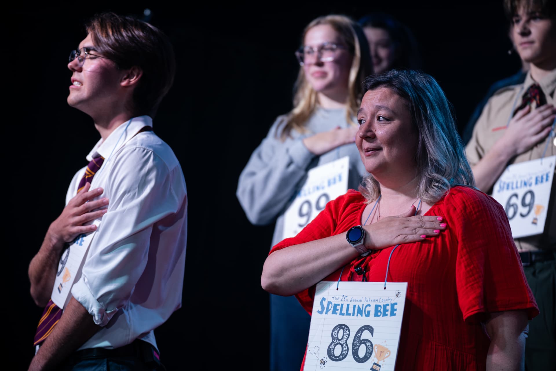 Richard Jordan with his hand over his heart beside a fellow speller during the Spelling Bee anthem