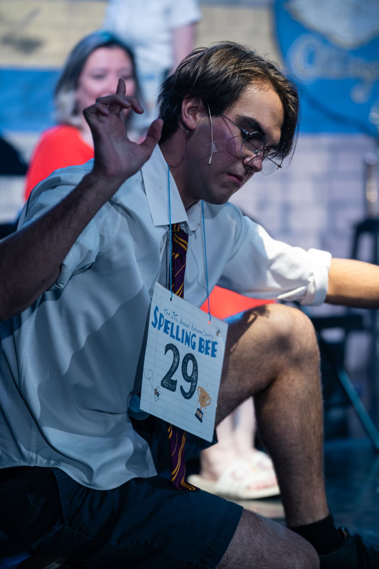 Richard Jordan crouching with an outstretched hand mid-spell in Putnam County Spelling Bee