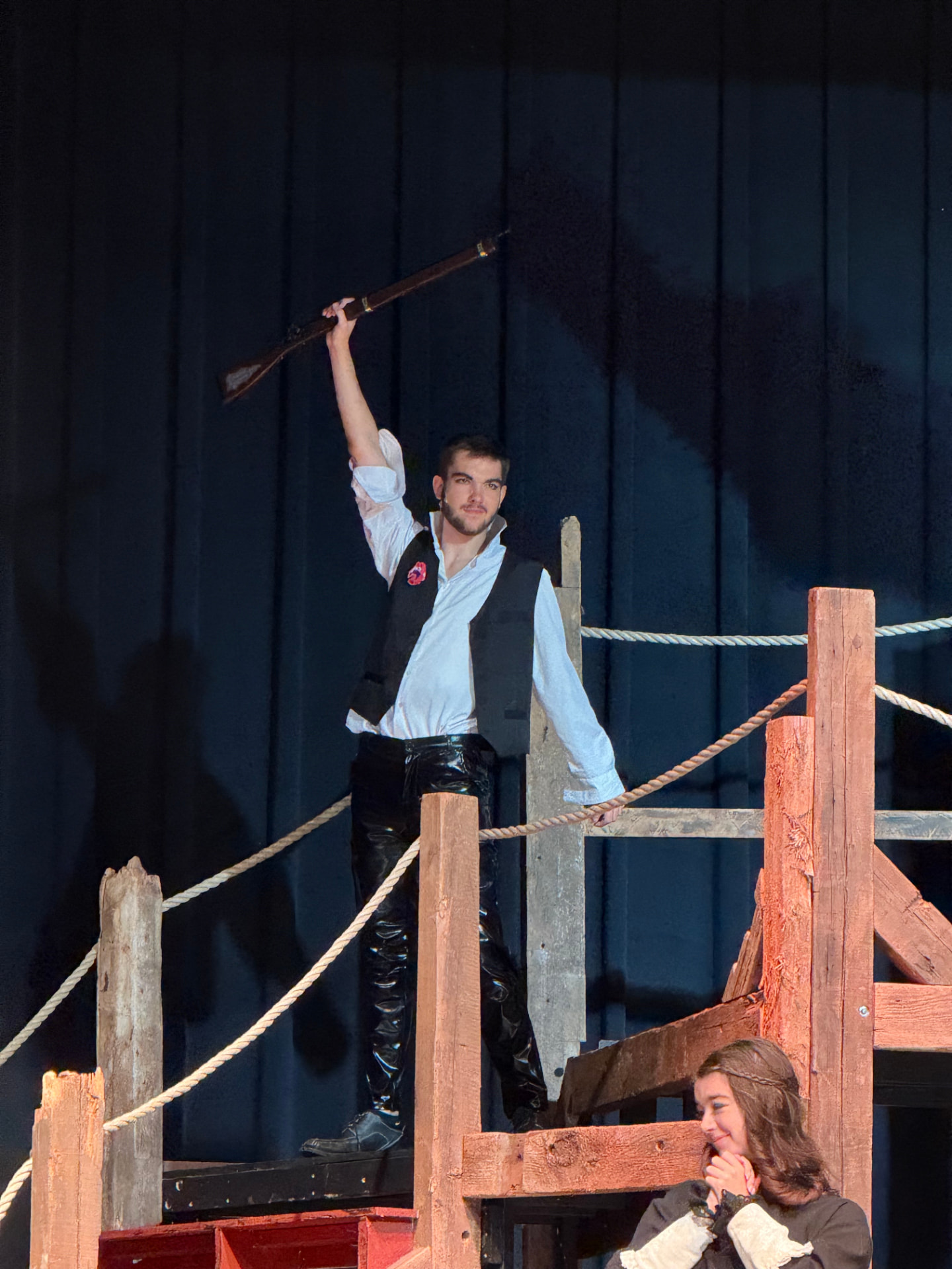 Richard Jordan as Enjolras raising a rifle atop the barricade